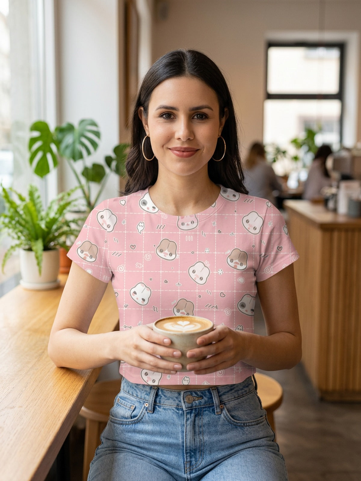 Pink kawaii toast-print crop t-shirt for women, styled with high-waisted jeans in a café